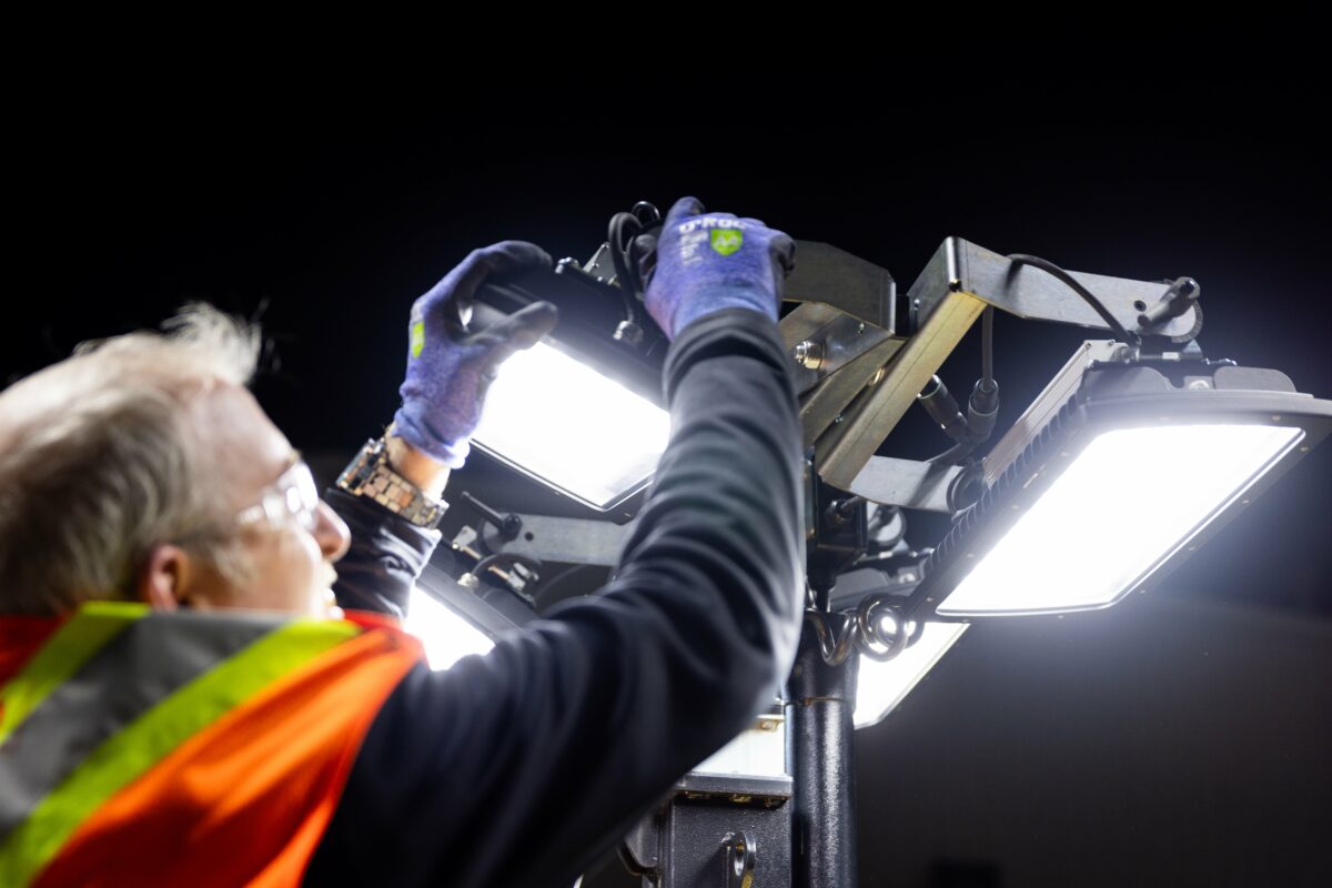 Technician adjusting Axiom Metro Light Tower at night