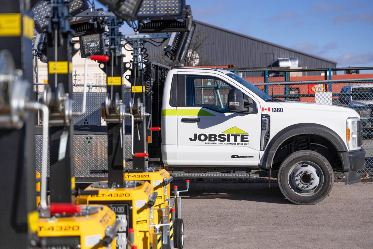 Jobsite truck parked beside Metro Light Towers at an industrial site