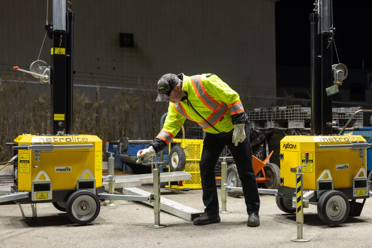 Technician adjusting Axiom Metro Light Tower at night