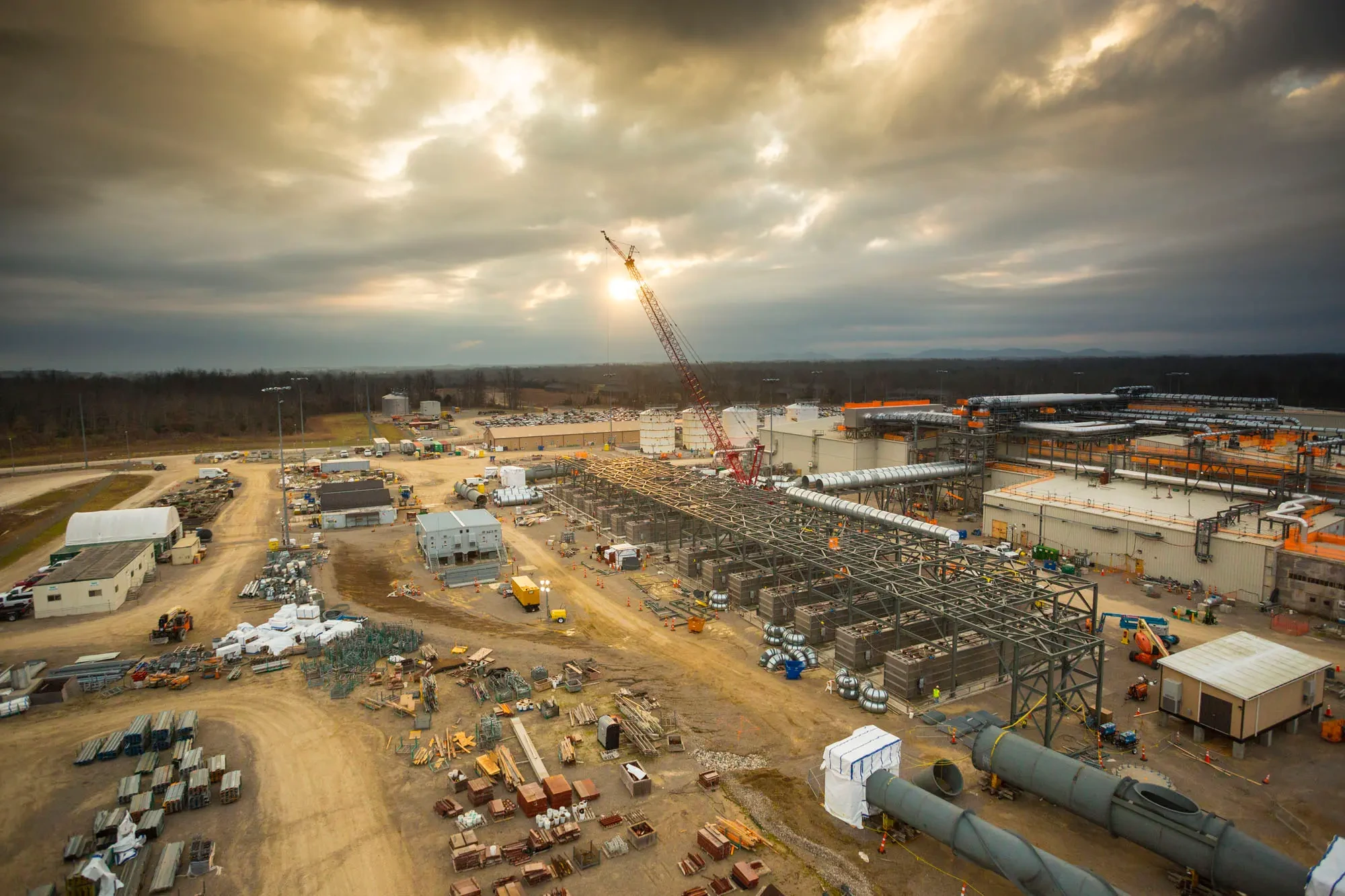 Expansive view of construction project site under clouds, showcasing cost-saving equipment and layout