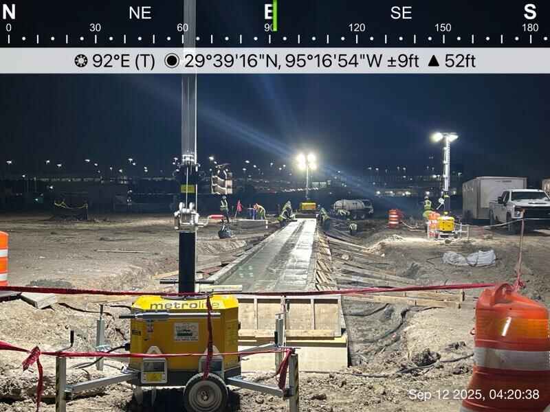 Hybrid light tower providing illumination for overnight construction work at Houston Airport during active night operations.